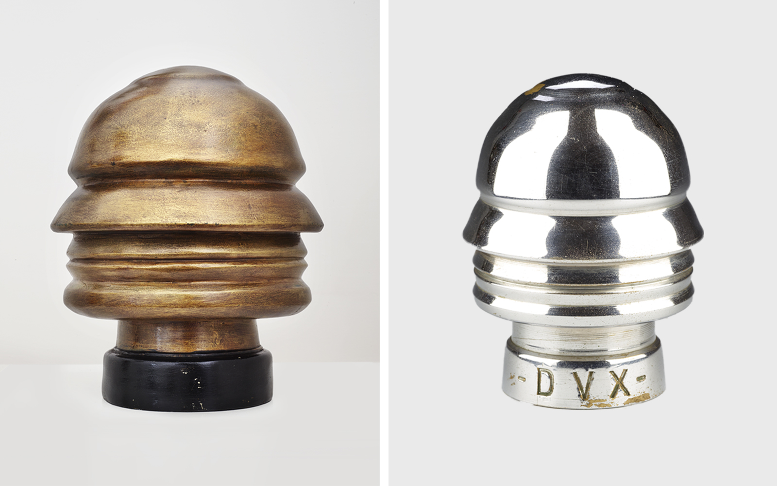 Two side-by-side objects with the same abstract, helmet-like shape. The one on the left is matte gold with a wooden or painted finish; the one on the right is polished silver-colored metal with the inscription “DVX” on the base.
